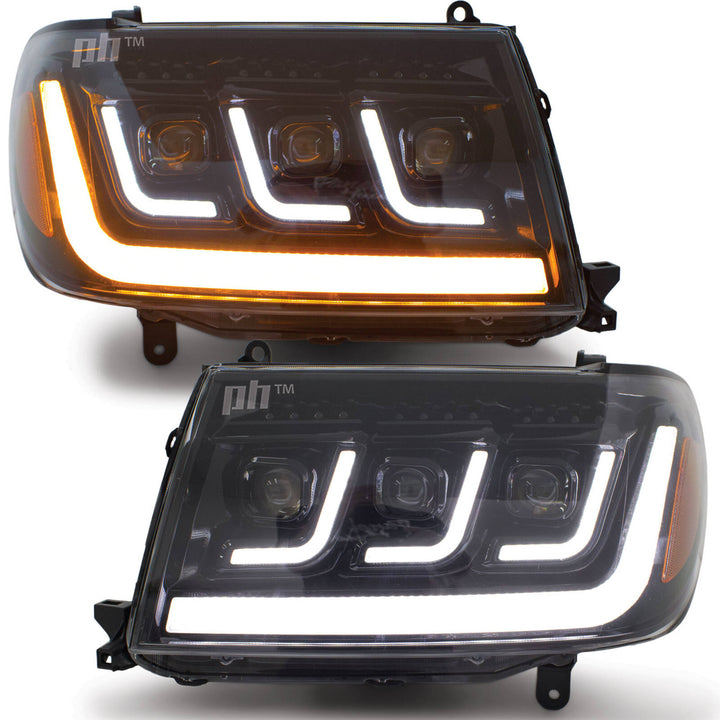 Headlights PAIR BLACK LED Triple Projector fits Toyota Landcruiser 100 Series 1998 - 2007