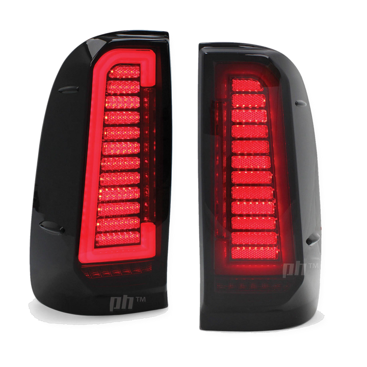 Pair of black car tail lights with red LED pattern on a white background